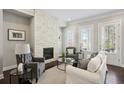 Elegant living room with a stone fireplace, bright windows, and stylish furniture for a cozy feel at 709 Bismark Ne Rd, Atlanta, GA 30324