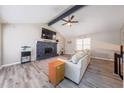 Cozy living room with vaulted ceilings, a stone fireplace, and ample natural light at 4520 Jackybell Trl, Decatur, GA 30034