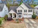 Aerial view of a charming two-story home, showcasing a well-manicured lawn and mature trees at 4829 Thicket Nw Path, Acworth, GA 30102