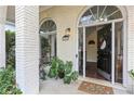 Inviting front porch with a decorated door and stylish decor, plants, and large arched windows at 4829 Thicket Nw Path, Acworth, GA 30102