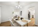 Elegant dining room with modern chandelier, white table, and seamless access to the kitchen at 2905 Dale Creek Drive Nw, Atlanta, GA 30318