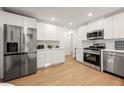 Modern kitchen boasts stainless steel appliances, white cabinetry, and ample countertop space at 2905 Dale Creek Drive Nw, Atlanta, GA 30318