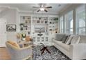Cozy living room with built-in shelving, neutral decor, and large windows providing ample natural light at 433 Cranleigh Se Rdg, Smyrna, GA 30080