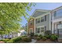 A well-maintained two-story townhouse with brick and siding exterior and landscaped front yard at 9155 Nesbit Ferry Rd # 65, Alpharetta, GA 30022