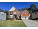 Beautiful two-story brick home with a well-maintained lawn and two-car garage offers classic curb appeal at 1721 Telfair Chase Way, Lawrenceville, GA 30043