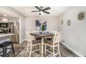 Dining area featuring wood-look floors, ceiling fan, a table with four chairs and a small painting at 2112 Palmyra Dr, Marietta, GA 30067