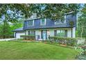 Inviting two-story home with a well-kept lawn, trimmed hedges, and a blue door, perfect for curb appeal at 2772 Dunnington Cir, Atlanta, GA 30341