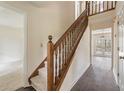 Traditional foyer showcasing hardwood floors, carpeted stairs, and natural light at 9992 Neuchatel Cres, Jonesboro, GA 30238