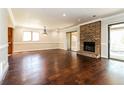 Spacious living room with hardwood floors, brick fireplace, and sliding door access to the backyard at 1603 Circlestone Dr, Stone Mountain, GA 30088