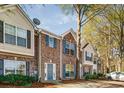 Brick facade townhome features a lovely blue door and trimmed windows at 2864 Parkway Close, Lithonia, GA 30058