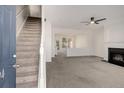 Open concept living room with a fireplace and a staircase to the upper level at 2864 Parkway Close, Lithonia, GA 30058
