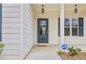 Welcoming front entrance with elegant lighting fixtures and a secure ADT security system at 1408 Seals Rd, Dallas, GA 30157