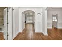 Inviting foyer with hardwood floors and an arched doorway at 2555 Stonevalley Ln, Cumming, GA 30041