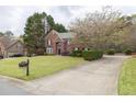 Beautiful brick home with mature landscaping and a long driveway at 2555 Stonevalley Ln, Cumming, GA 30041