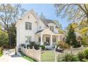 Beautiful white home with a welcoming porch, lovely landscaping, and classic white picket fence at 2877 Elliott Ne Cir, Atlanta, GA 30305