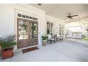 Inviting front porch with double doors, cozy seating area, and a relaxing porch swing at 2877 Elliott Ne Cir, Atlanta, GA 30305