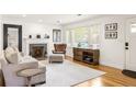 Inviting living room with a classic fireplace, hardwood floors, and ample natural light at 417 Lynnhaven Sw Dr, Atlanta, GA 30310