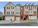 Inviting townhome with classic architectural details, red shutters, and a convenient two-car garage at 5987 Turfway Park Ct, Sugar Hill, GA 30518