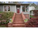 Inviting front entrance featuring a brick staircase and beautifully landscaped flower beds at 215 Terrace Ne Dr, Atlanta, GA 30305