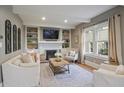 Bright living room with fireplace, built-in shelves, and hardwood floors at 215 Terrace Ne Dr, Atlanta, GA 30305