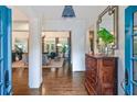 Elegant foyer featuring hardwood floors, a decorative mirror, and a glimpse into the living room at 135 High Point Walk, Atlanta, GA 30342