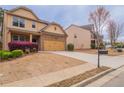 Two-story home with two-car garage, long driveway, and well-maintained landscaping at 1498 Scenic Pines Dr, Lawrenceville, GA 30044