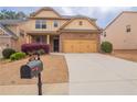 Two-story home featuring attached two-car garage, concrete driveway, and lovely landscaping at 1498 Scenic Pines Dr, Lawrenceville, GA 30044