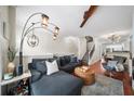 Comfortable living room with seating, stylish light fixtures, and staircase at 1741 Liberty Nw Pkwy, Atlanta, GA 30318