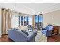 Cozy living room featuring hardwood floors, a large window with city views, and comfortable seating at 3481 Lakeside Ne Dr # 2203, Atlanta, GA 30326