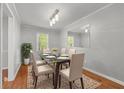 Dining room with natural light, modern lighting, and a glass table at 904 Little River Ln, Woodstock, GA 30189