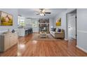 Cozy living room with hardwood floors, fireplace, and open access to the modern kitchen at 904 Little River Ln, Woodstock, GA 30189