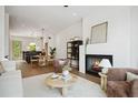 Bright living room with fireplace, hardwood floors, and a view into the dining area and kitchen at 1570 Flat Shoals Se Rd # 4, Atlanta, GA 30316