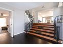 Inviting entryway with dark wood floors, staircase with ornate railings, and open view to the living area at 819 Venetta Nw Pl, Atlanta, GA 30318