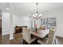 Bright dining room with wainscoting, a stylish wood table, and a decorative sideboard at 1895 Weston Ln, Tucker, GA 30084