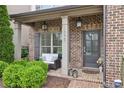 Inviting front porch with brick detail, cozy seating, and stylish decor at 1895 Weston Ln, Tucker, GA 30084