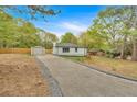 Exterior of a home featuring a long driveway leading up to the house and detached garage at 484 Lorene Sw Dr, Marietta, GA 30060