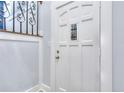 Front door with decorative window in entryway, providing a bright and secure entrance at 921 Creekdale Dr, Clarkston, GA 30021