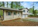 The facade includes a covered porch with a two-car garage, blending comfort and practicality seamlessly at 3309 Poplar Dr, Lawrenceville, GA 30044