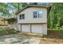 A view of the home's front, highlighting the convenient two-car garage and the surrounding greenery at 3309 Poplar Dr, Lawrenceville, GA 30044