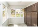 Bright sun room featuring large windows, tile floors and built in cabinets at 5798 Salem Rd, Covington, GA 30016