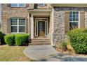 Inviting front entrance features a classic door, brick steps, and manicured landscaping at 1250 Edgebrook Ln, Snellville, GA 30078