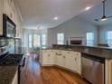 Bright kitchen with stainless steel appliances, granite countertops, hardwood floors and open floorplan at 2004 Westover Nw Ln, Kennesaw, GA 30152