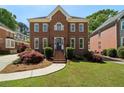 Beautiful brick home with manicured lawn, mature landscaping, and traditional architectural details at 2849 Livsey Woods Dr, Tucker, GA 30084