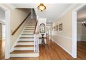 Inviting foyer featuring hardwood floors, staircase, traditional decor, and ample natural light at 2849 Livsey Woods Dr, Tucker, GA 30084
