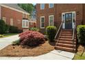 Brick home featuring traditional architectural details, manicured landscaping, and a welcoming front door at 2849 Livsey Woods Dr, Tucker, GA 30084