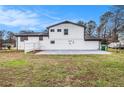A view of the fenced backyard and a brick and white exterior on this home at 3862 Northstrand Dr, Decatur, GA 30035