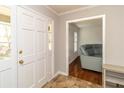 Foyer features white front door and neutral walls, opening into a living space with hardwood floors at 1468 Cheyenne Ct, Stone Mountain, GA 30087