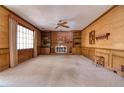 Spacious carpeted living room featuring a brick fireplace flanked by built-in shelving units and a large picture window at 1510 Wood Thrush Way, Marietta, GA 30062