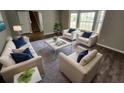 Tastefully decorated living room with new wood flooring, modern furniture, and lots of natural light at 3763 Waldrop Hills Dr, Decatur, GA 30034