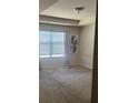 Spacious carpeted bedroom with large window and sheer curtains, filled with natural light at 6311 Olmadison Pl, Atlanta, GA 30349